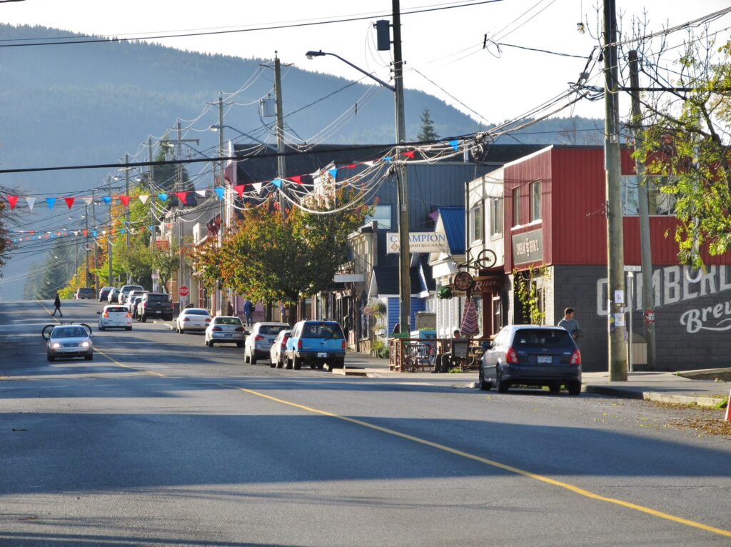 Main street in a Canadian community, with mountains in the background.